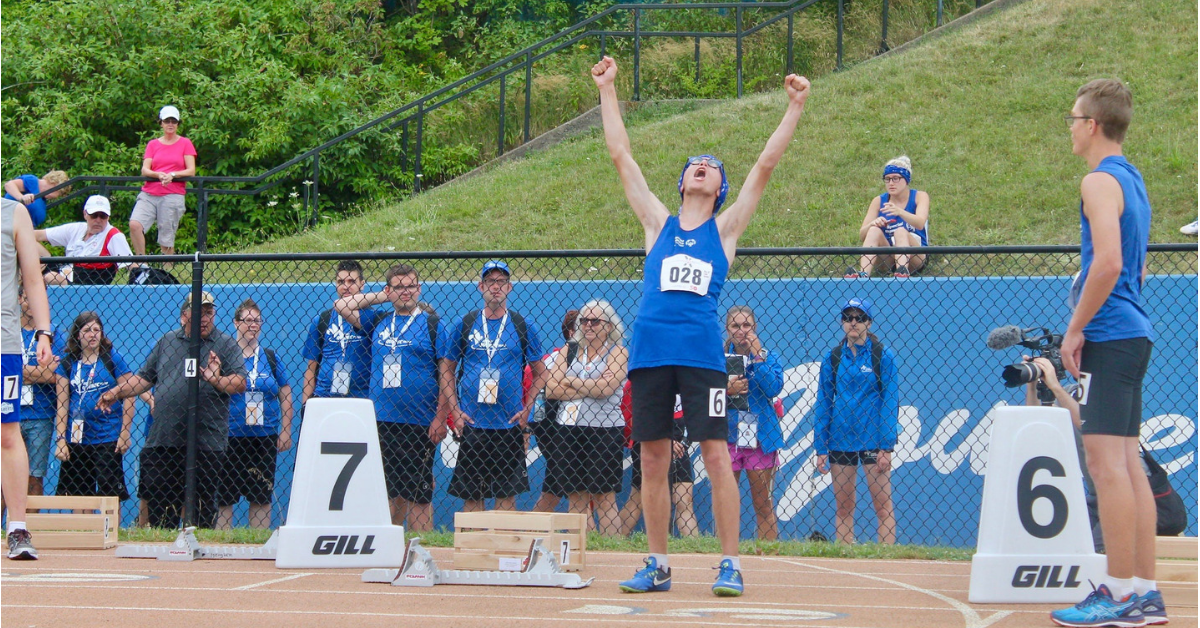 A Special Olympics athlete cheers at National Games.