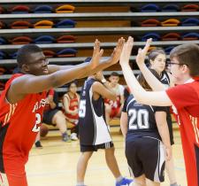 Athletes high five at a ASAA Unifed Sport event