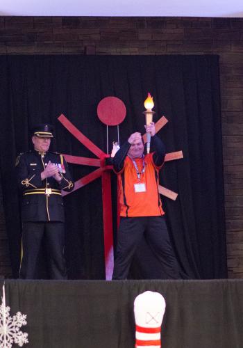 LETR Officer and Special Olympics Athlete Melvin Hanhams holding the SO torch about to light the cauldron