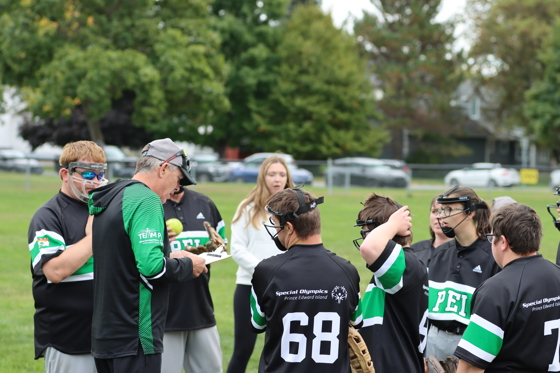 Team PEI Softball competing at the 2024 SONB Invitational, Special Olympics PEI, Softball, Coach with Group of Athletes