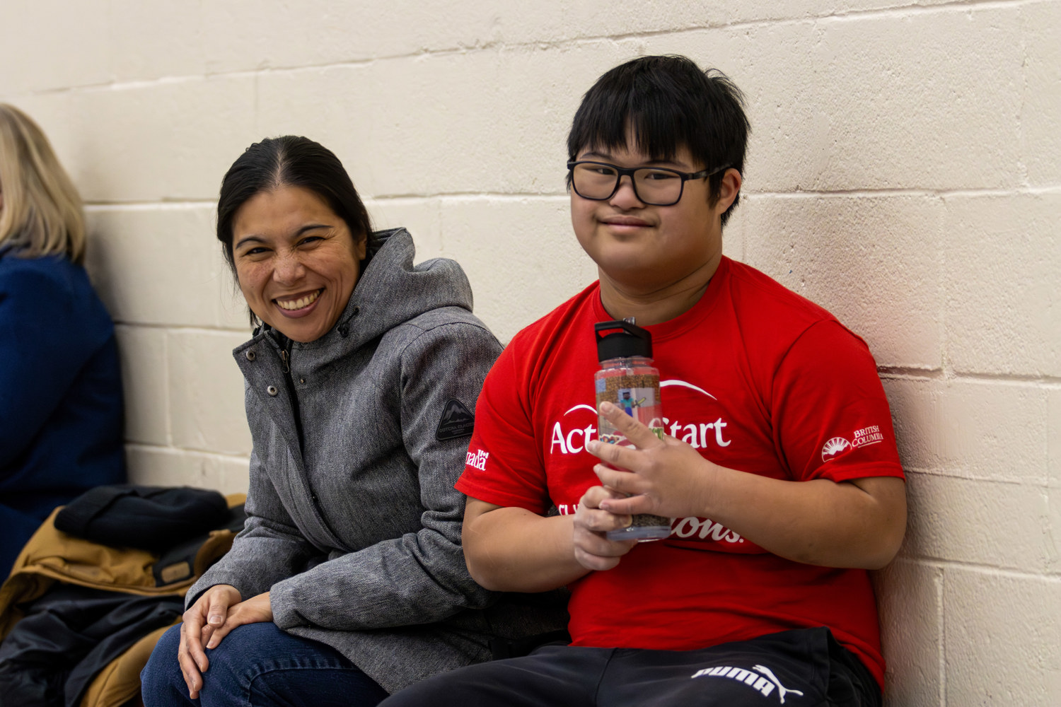 Specical Olympics BC athlete Marcus poses together with his mom.