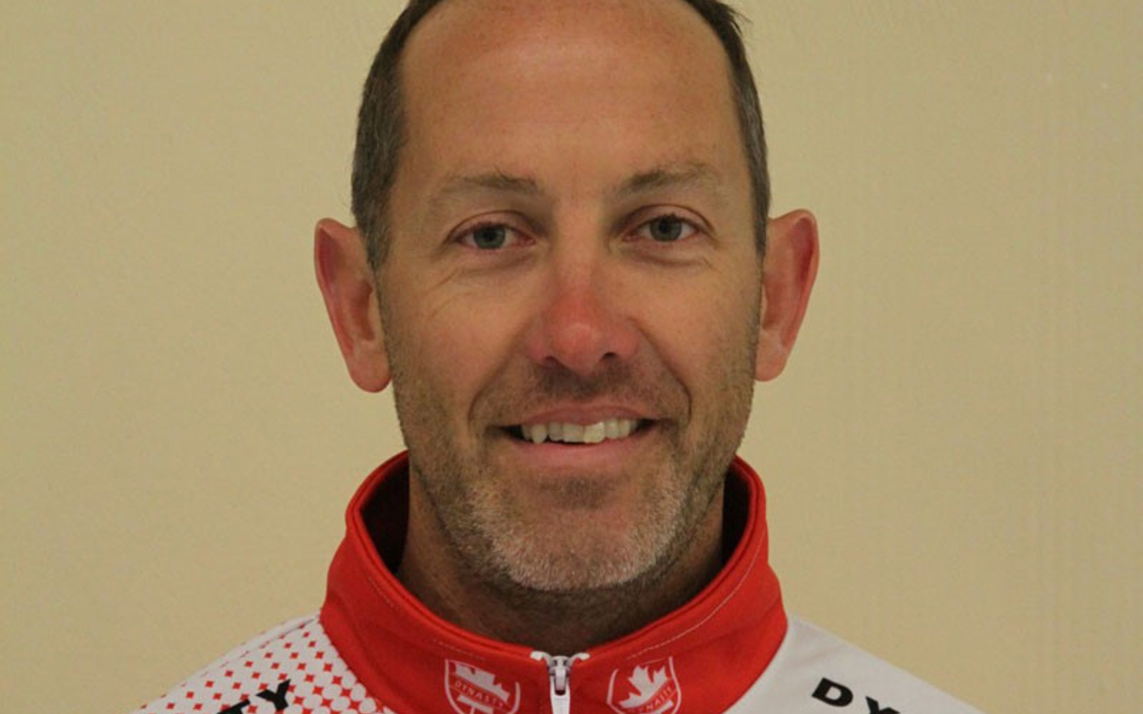 Headshot of a man wearing a curling jacket.