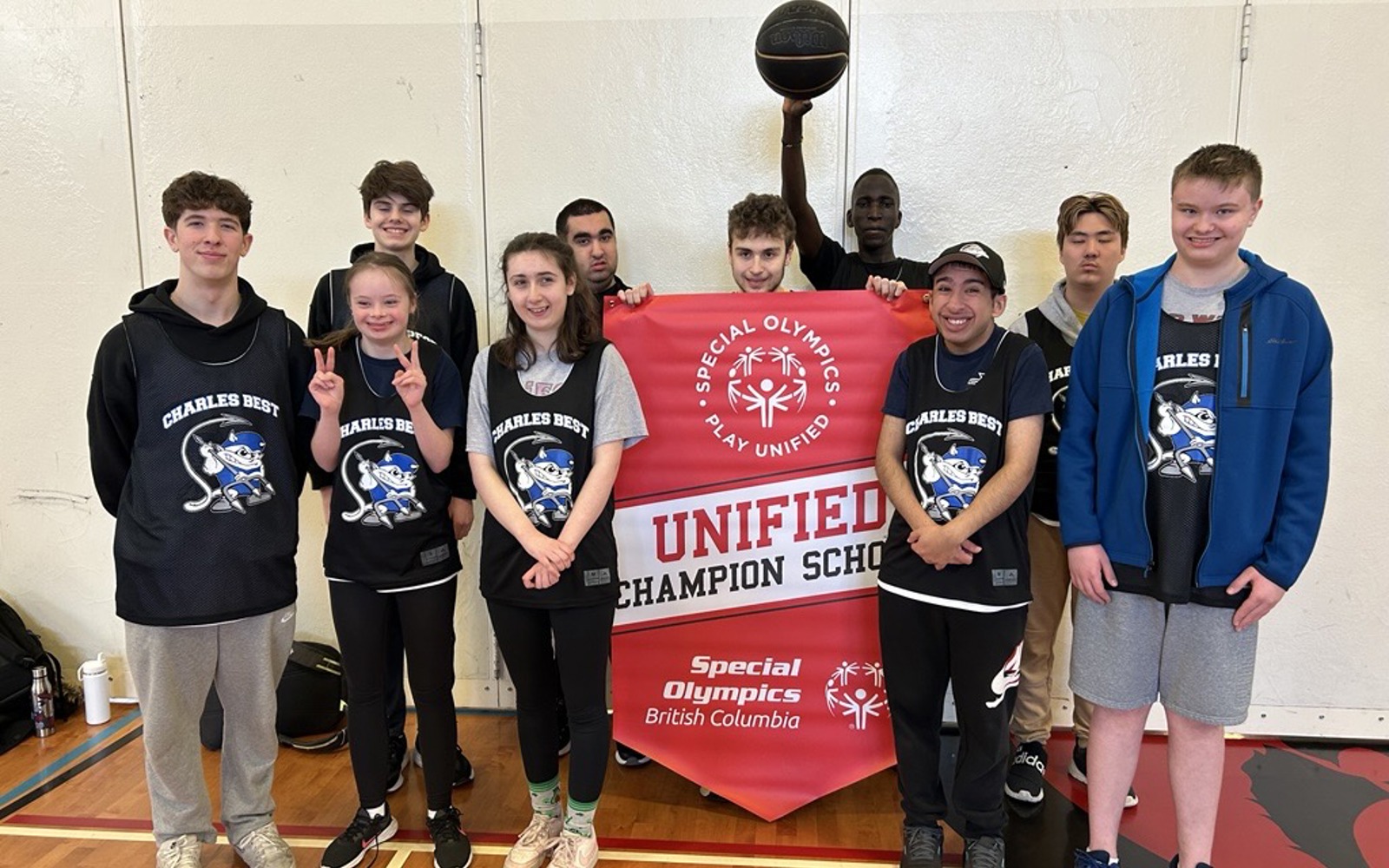 Students stand with a Unified Champion School banner.