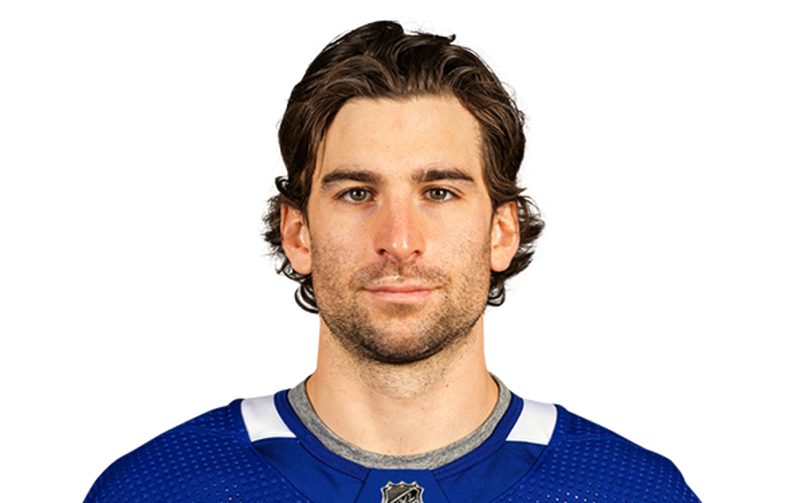 Headshot of a man in a blue hockey jersey