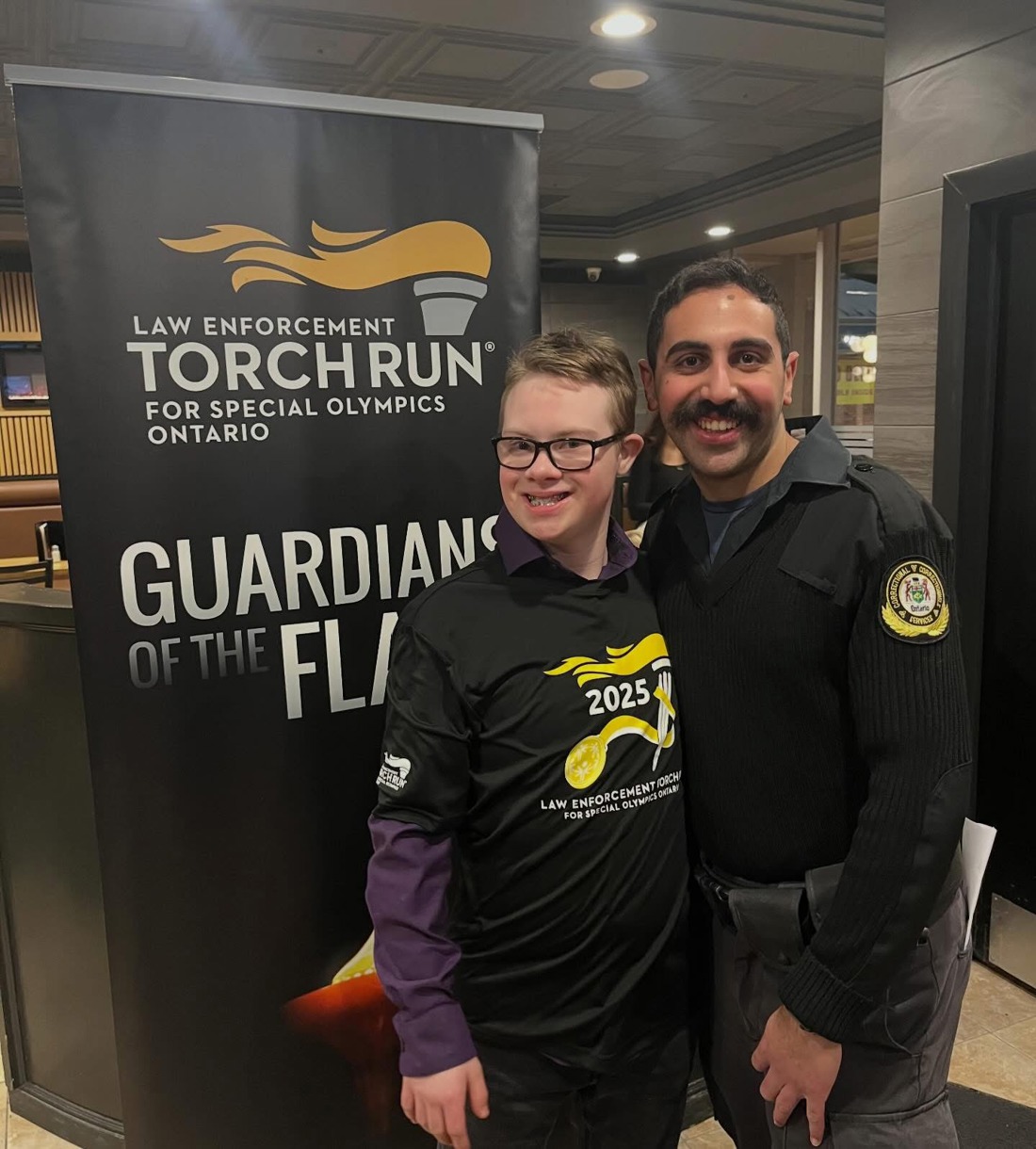 Gage and an Officer at the Law Enforcement Torch Run. 