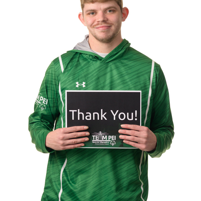 Team PEI 2026 Swimming athlete, Matthew Gallant, standing with a thank you sign
