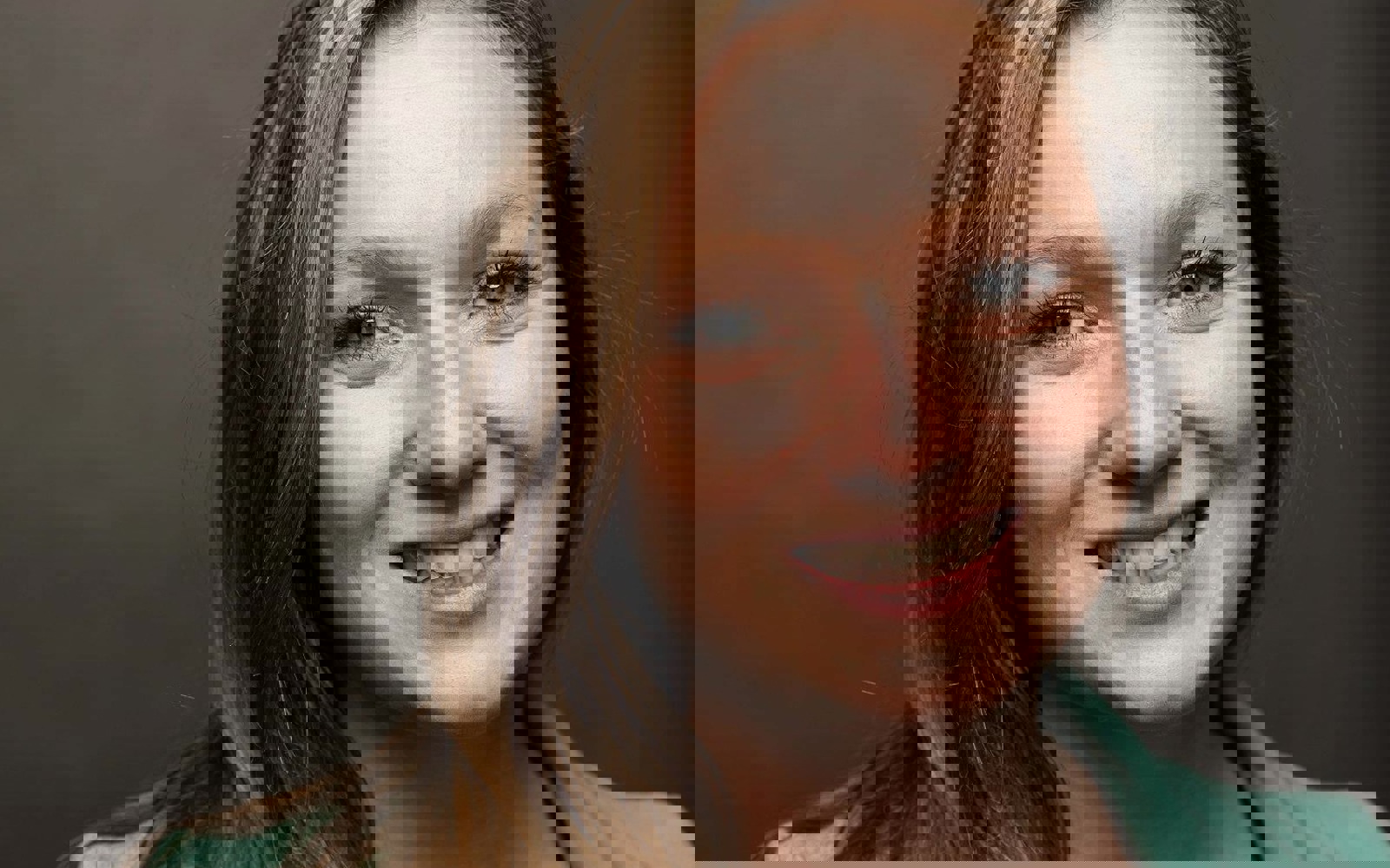 Headshot of a woman with long blond hair in a pale green blazer.