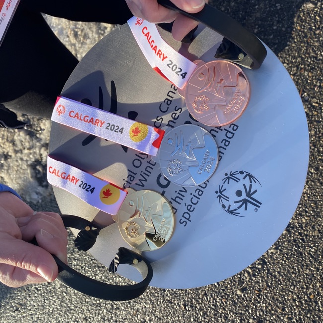 A close up image of gold, silver, and bronze medals.