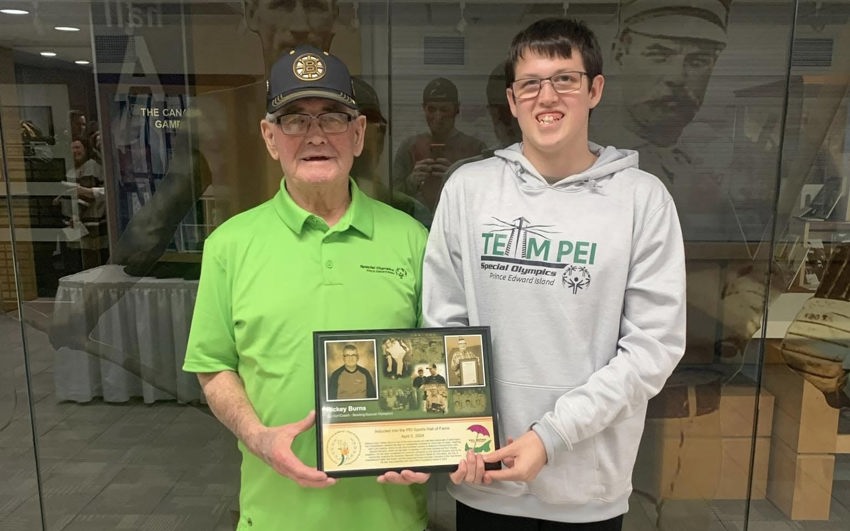 Rickey Burns following his induction in the PEI Sports Hall of Fame, standing with his grandson