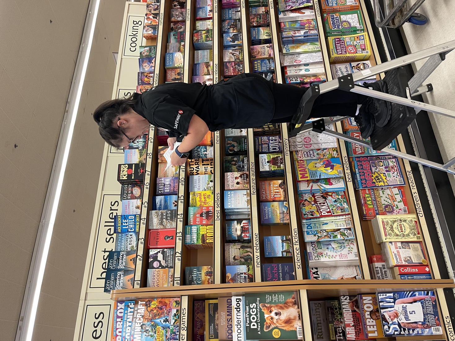 Allie Price, Empire Employee and Special Olympics Athlete, stocking book shelves at the Safeway store she works at. 