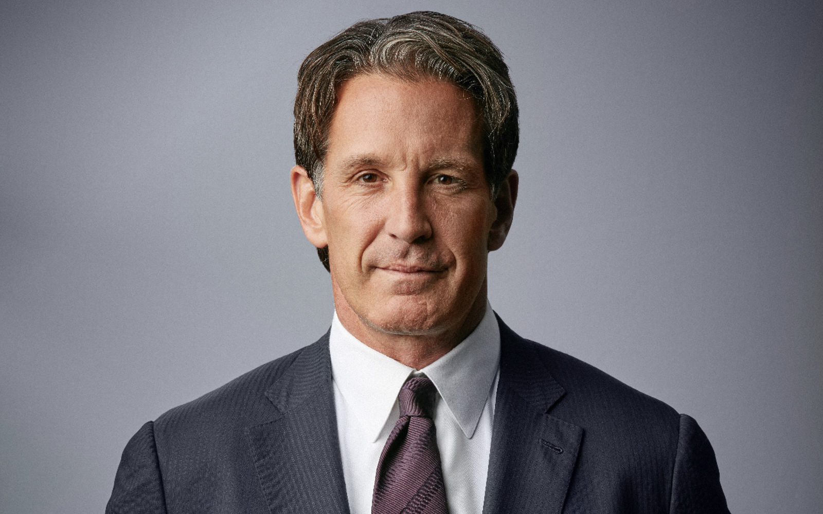 Headshot of a man wearing a suit.