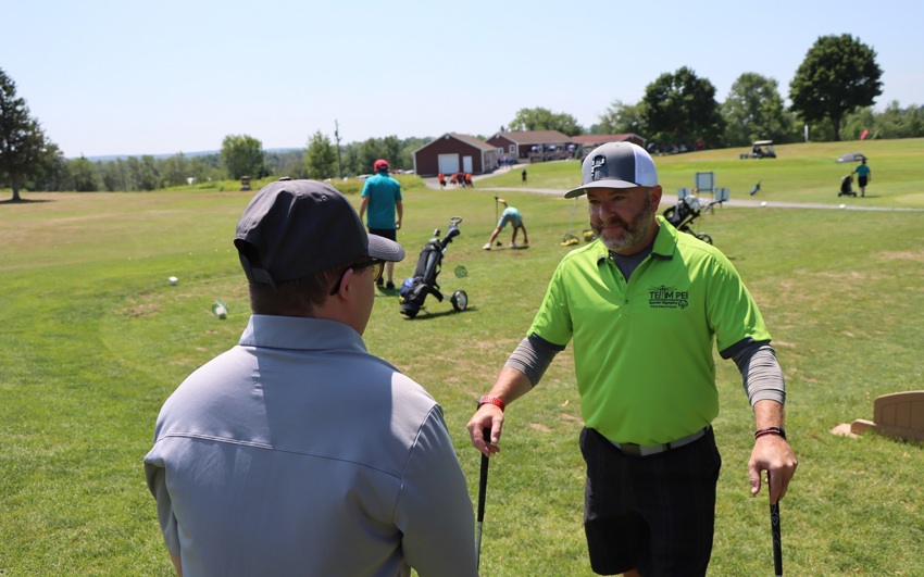 Team PEI 2026 Golf athlete, Colton Matheson, talking with Coach / Caddie on golf course