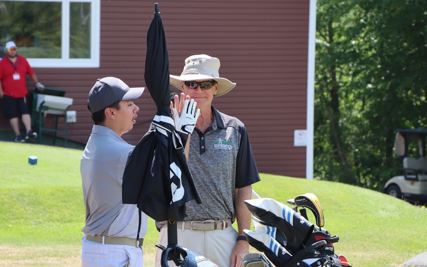 Team PEI 2026 Golf athlete, Matthew Jehn, giving his Coach / Caddie a high five