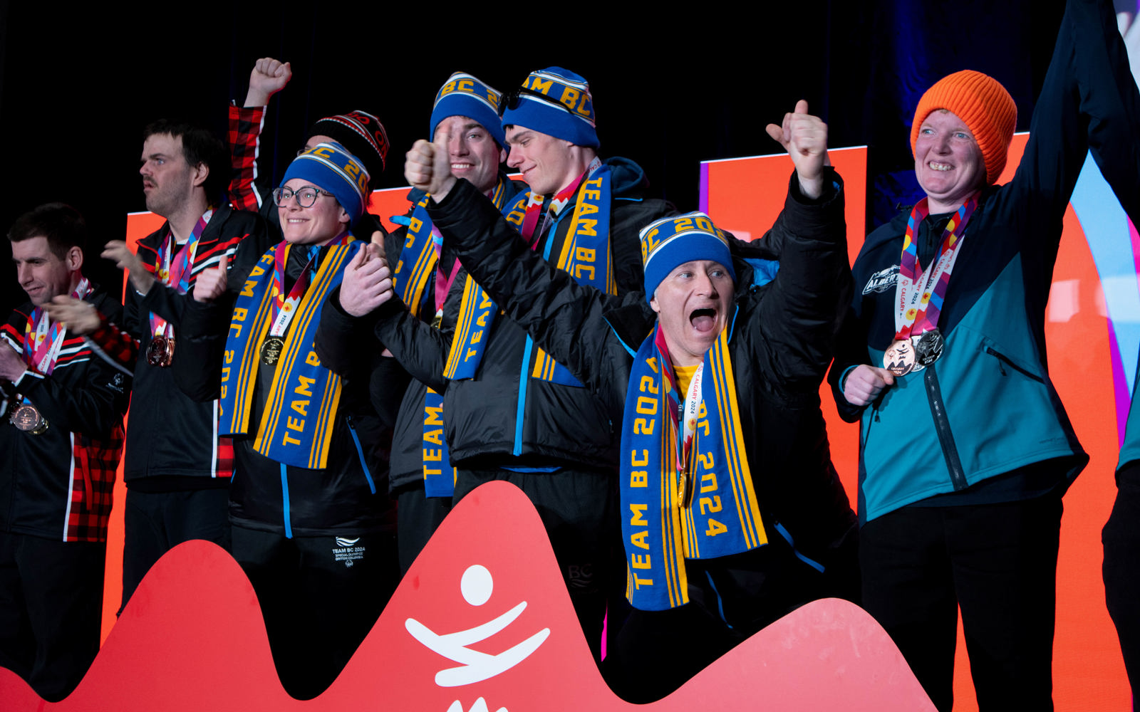 A group of Special Olympics BC athletes show excitement and joy as they receive their medals at the 2024 Special Olympics Canada National Winter Games in Calgary.