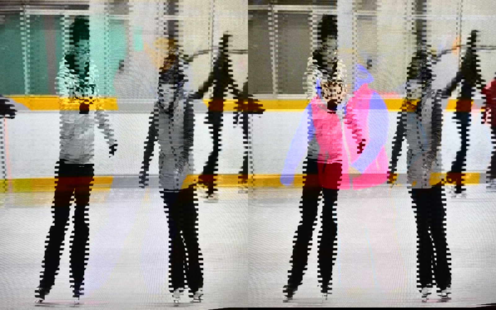 two people on an ice rink, practicing skating. 