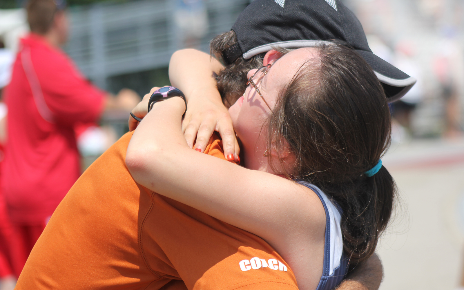Athlete and coach hug