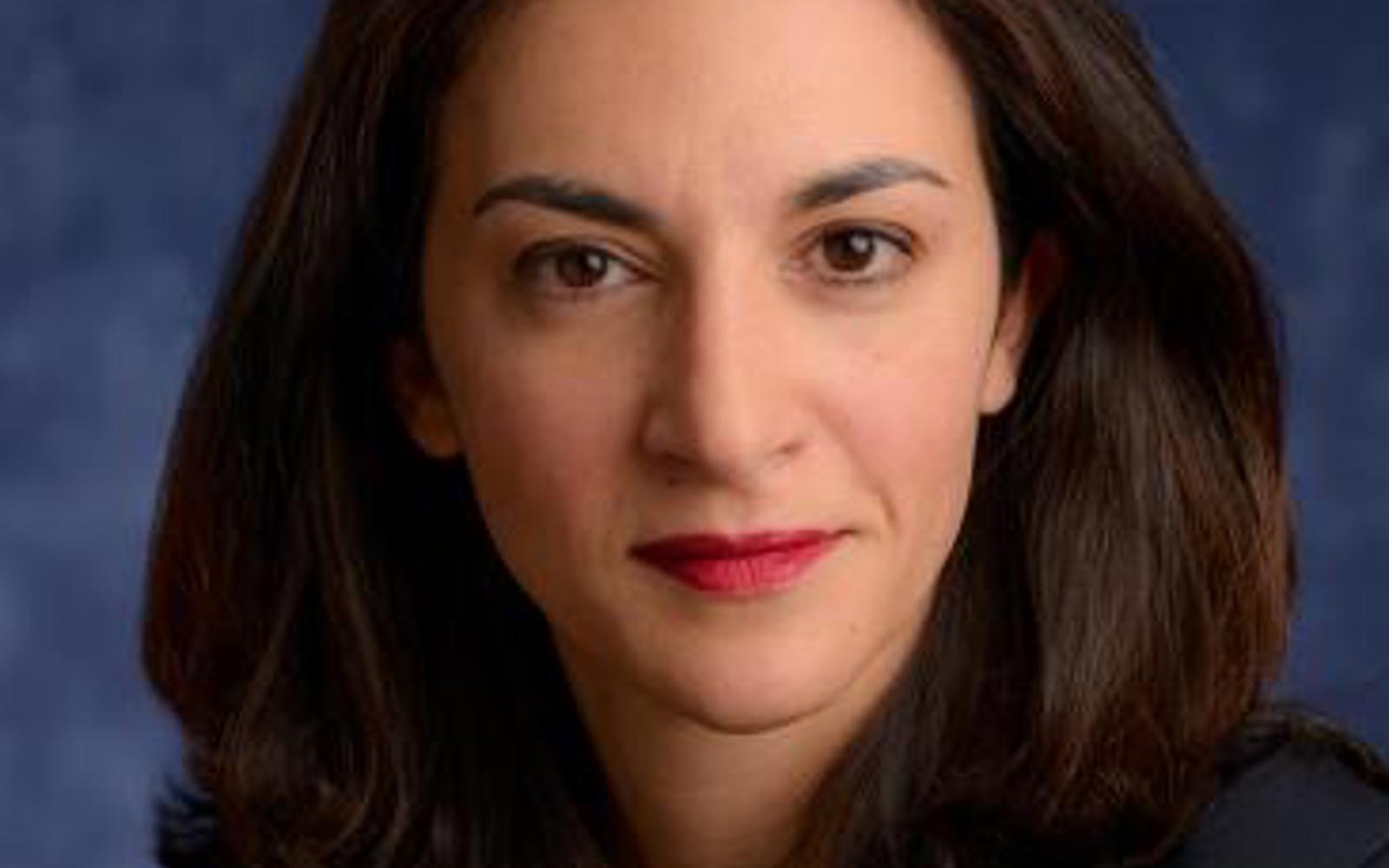 Image of a woman's face with long dark hair. 