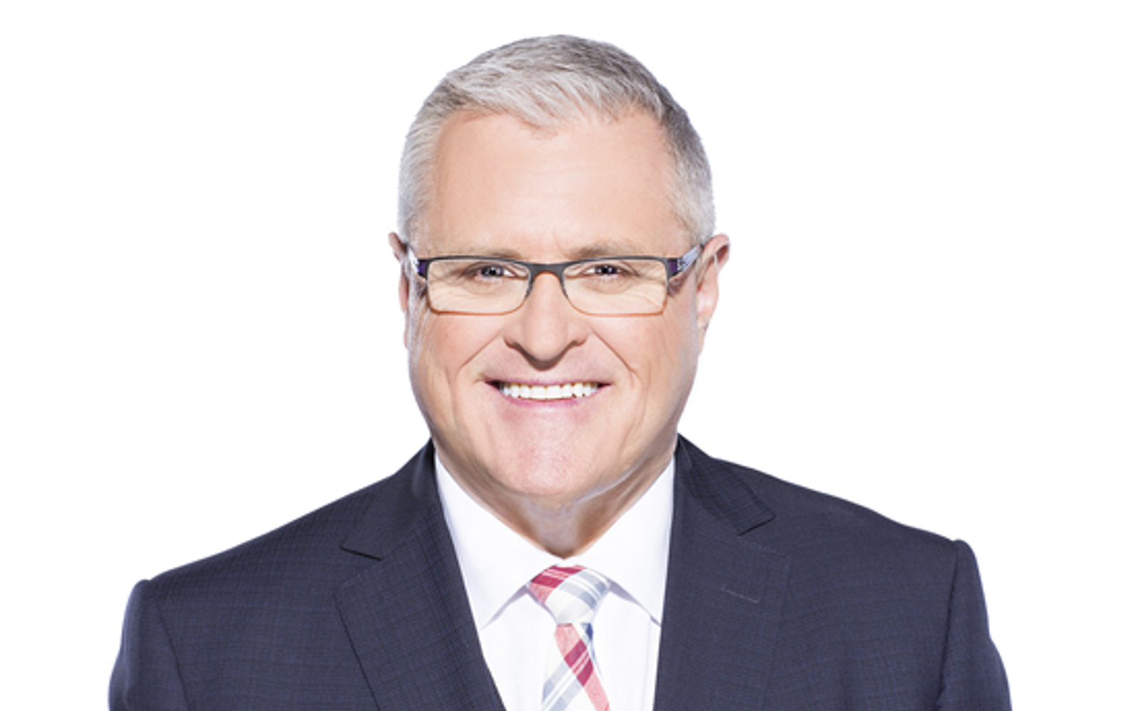 Headshot of a man wearing a suit.