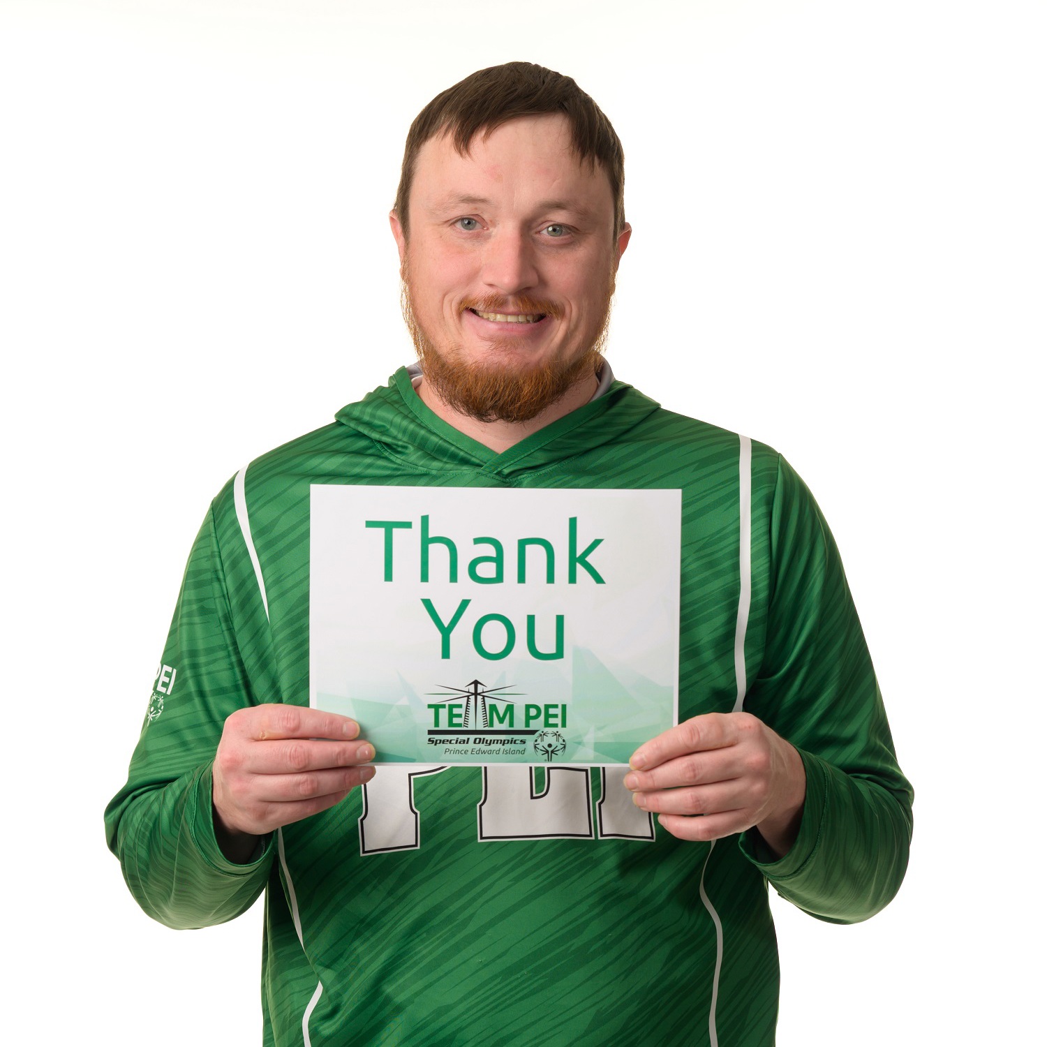 Team PEI 2026 Athletics athlete, Jeremy Wall, standing with a thank you sign