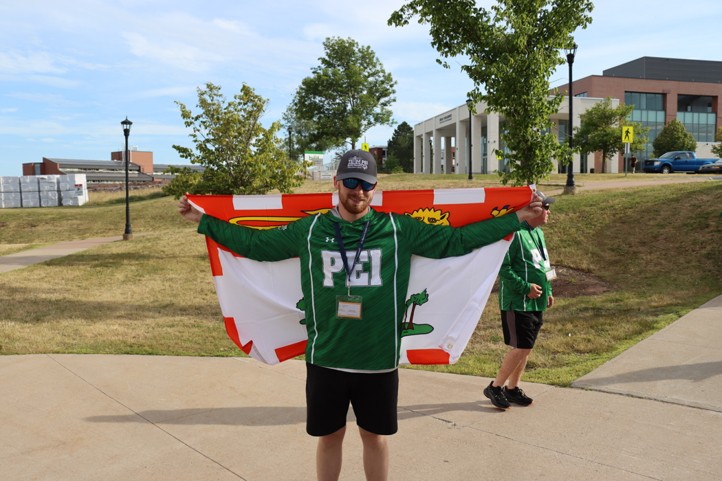 SOPEI Athlete Logan Robbins holding the Team PEI flag at the SONS games July 2025