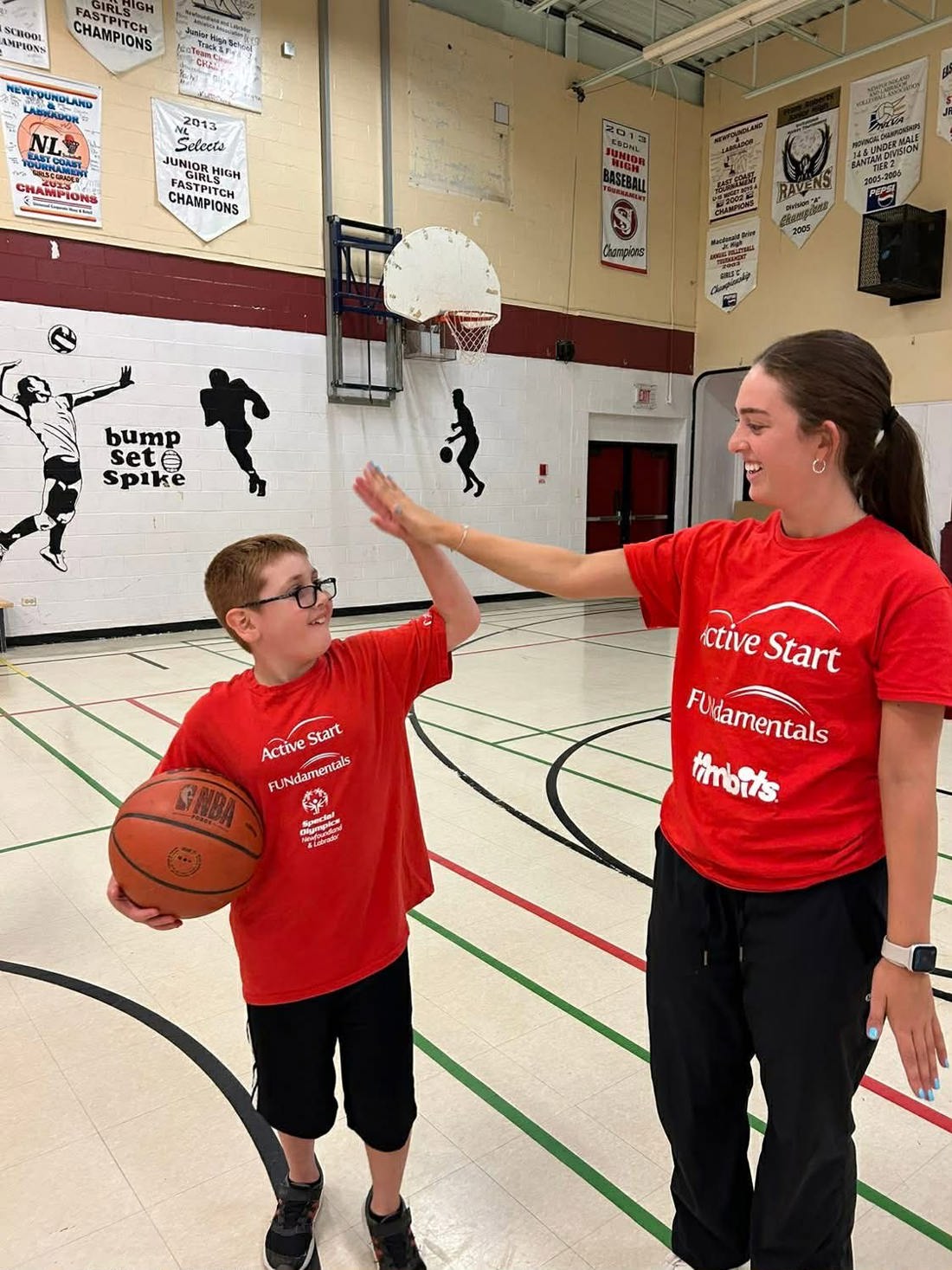 Alexander high-fiving a volunteer. 