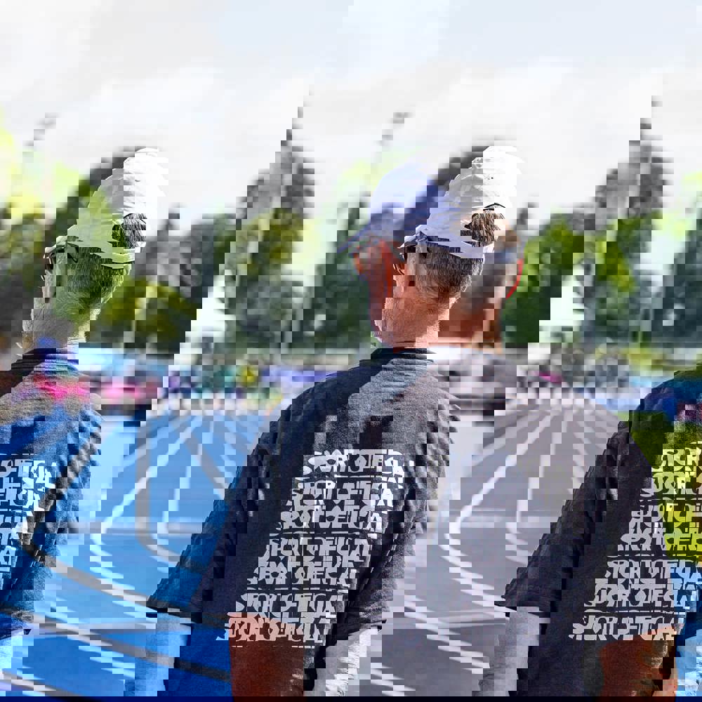 Man in black sport official shirt on a racetrack