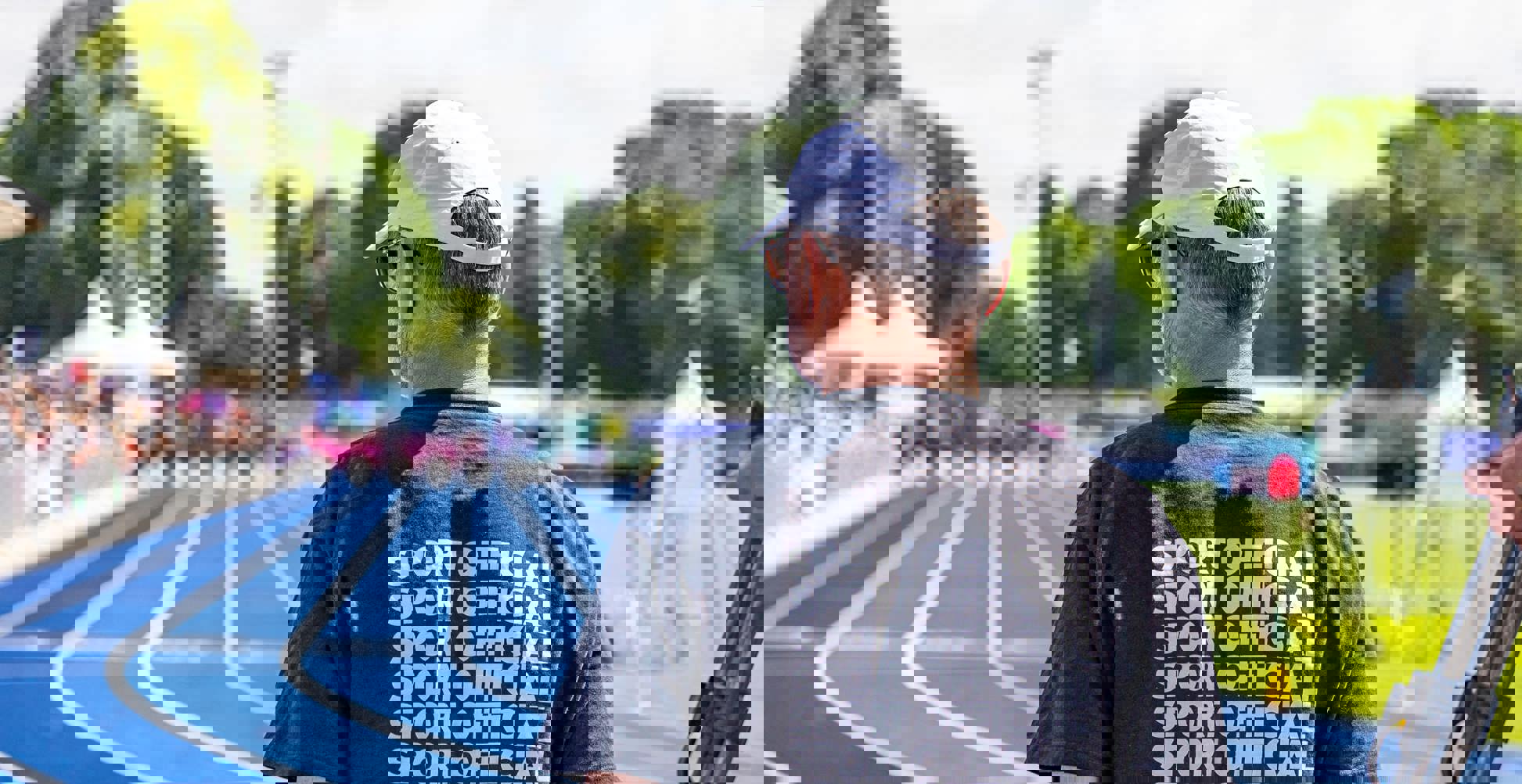 Man in black sport official shirt on a racetrack