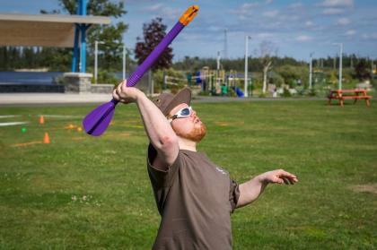 Athlete throwing mini javelin