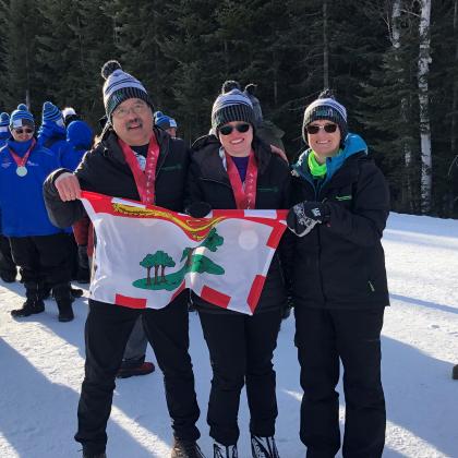 Special Olympics PEI, Team PEI, 2 Athletes with Coach Outside, PEI Flag