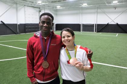 "Eddie and Canadian women's soccer player Diana Matheson hold her Olympic bronze medals.
