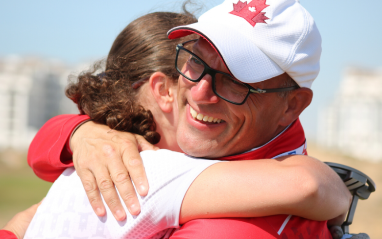 A coach hugs his athlete.