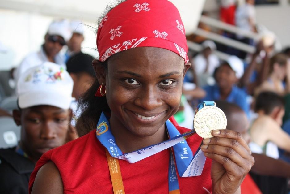 "Monique Shah holds up her medal at the Special Olympics World Games in Athens 2011.