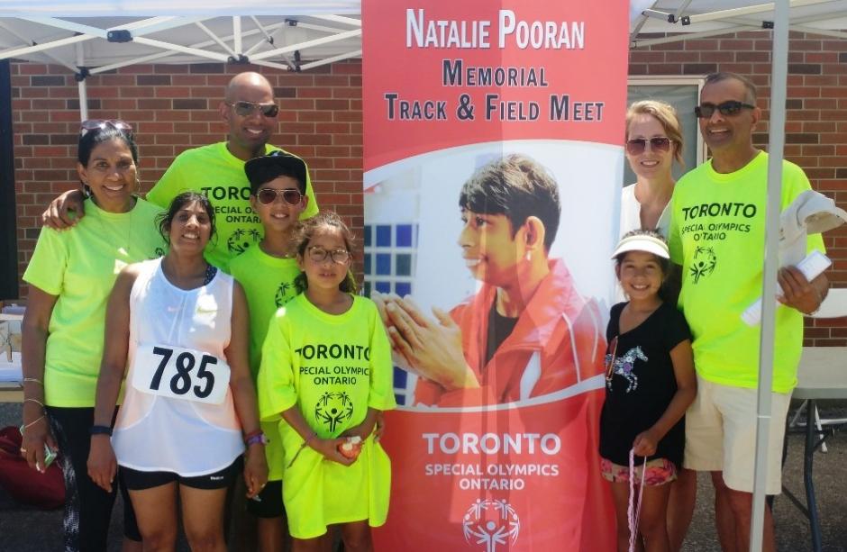 The Pooran family stand for a photo at the Natalie Pooran Memorial Track Meet in 2018