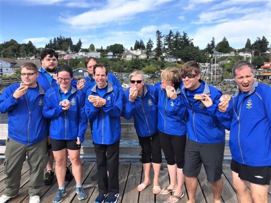 Team B.C. members pose on a dock with their Special Olympics Donuts.