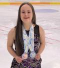 Julia Romualdi with her medals on the ice