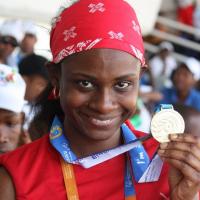 Monique Shah holds up her medal at the Special Olympics World Games in Athens 2011