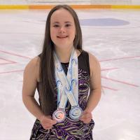 Julia Romualdi with her medals on the ice