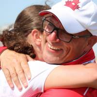 SO Team Canada 2019 golf coach Glenn Cundari hugs one of his athletes.