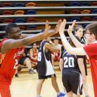 Athletes high five at a ASAA Unifed Sport event