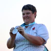 "Erin Thom is all smiles as she receives her silver medal after four days on the golf course."
