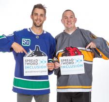 Brandon Sutter and Michael Langridge holding Spread the Word Inclusion signs