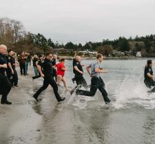 Participants running into cold waters 