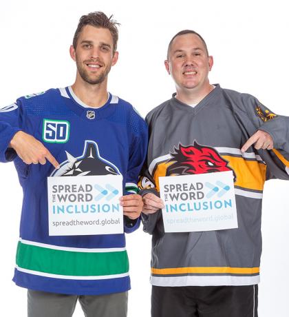 Brandon Sutter and Michael Langridge holding Spread the Word Inclusion signs