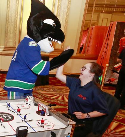 FIN gives SOBC – Abbotsford athlete Paige Norton a high-five at the 2019 SCF. Photo by Jeff Vinnick courtesy of the Vancouver Canucks.
