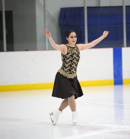 Special Olympics Alberta figure skater JorDen Tyson takes a bow on the ice.