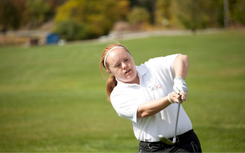 Special Olympics golfer Tess Trojan swings a golf club