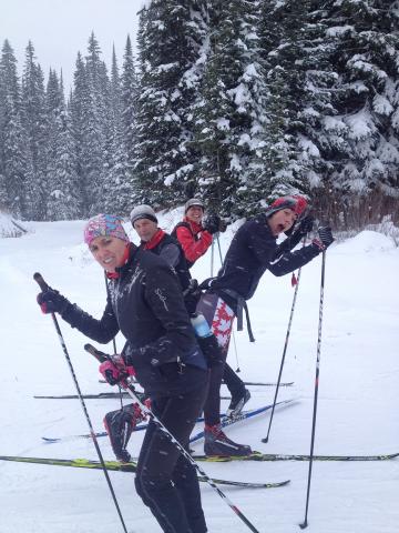 "Coaches Annabel Stanley, Garth Vickers & athletes Francis Stanley and Tracey Melesko pose for a photo in the snow holding their ski poles.""