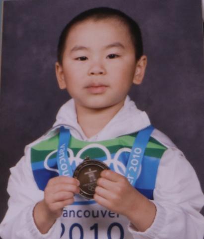 Ezekiel, four, holding a toy medal and wearing a Team Canada uniform.