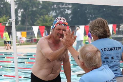 SOBC swimming athlete high-fiving volunteer