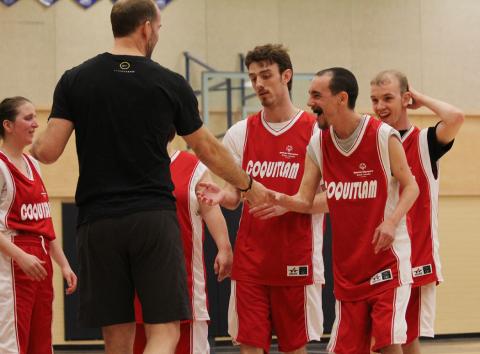 SOBC - Coquitlam basketball athletes celebrating with coach
